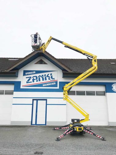 Arbeitsbühne mit Arbieter auf Dachhöhe